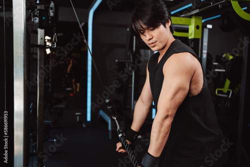 Man working out with weights training machine exercise lifting dumbbells at fitness gym. Fitness muscular body weight loss. Bodybuilding healthy lifestyle.