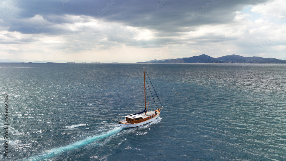 Fototapeta premium Aerial drone photo of wooden sail boat cruising deep blue Mediterranean sea