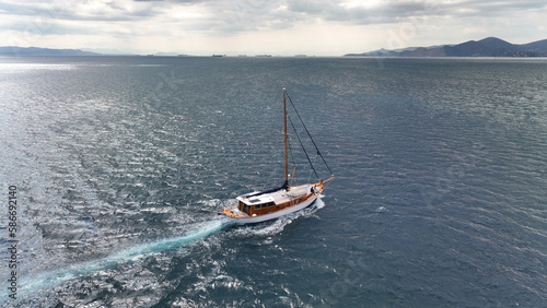 Aerial drone photo of wooden sail boat cruising deep blue Mediterranean sea