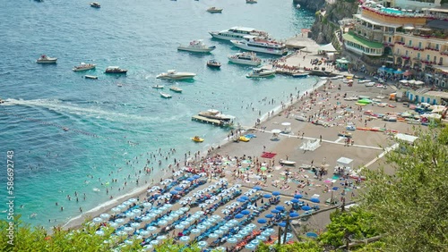 View of the most recognizable Marina Grande Beach Positano in 4K. Amazing view from above over the beautiful colorful houses and boats with the turquoise beach in Positano, Amalfi Coast. photo
