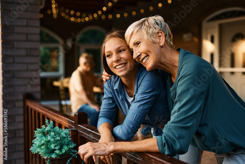Wallpaper Mural Embraced grandmother and granddaughter enjoying on terrace. Torontodigital.ca