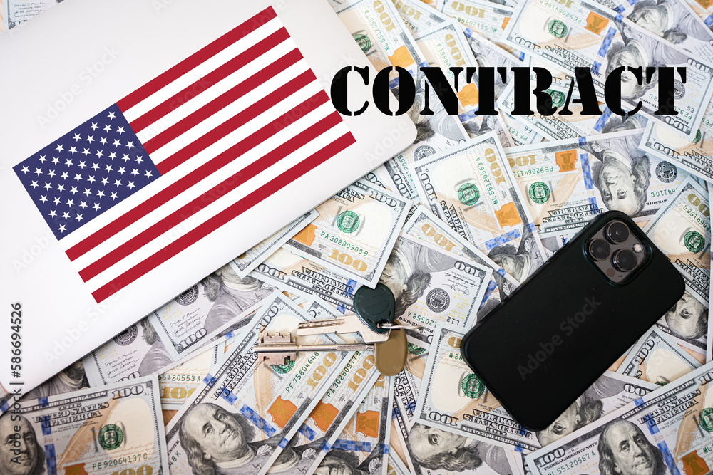 Contract concept. USA flag, dollar money with keys, laptop and phone background.