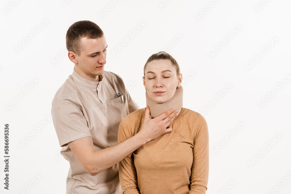 Traumatologist puts soft collar or bandage on girl to stabilize cervical region in case of neck pain, injuries and sprains on white background. Traumatologist puts soft collar or bandage on girl to stabilize cervical region in case of neck pain, injuries and sprains on white background.