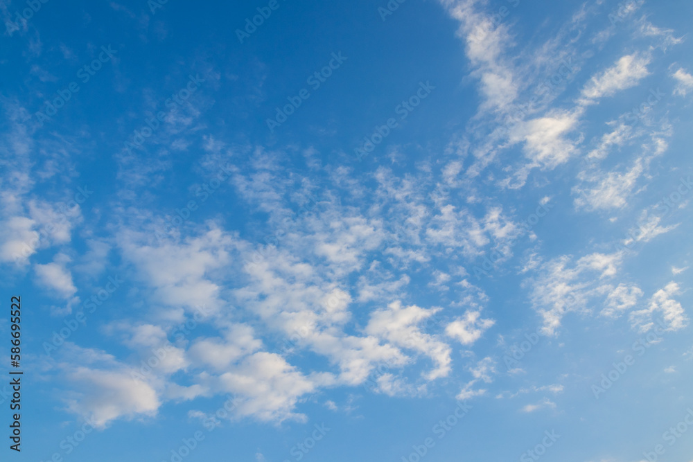 blue sky decorated with little clouds, horizontal scenery 
