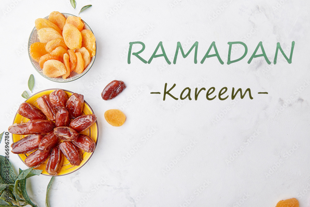 Fototapeta premium Ramadan Kareem text background. Healthy desserts. Fast diet food - dried apricots, dates
