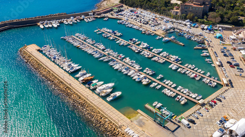 Aerial view of the marina and port of Santa Marinella, in the Metropolitan City of Rome, Italy. There are many boats moored at the harbour.