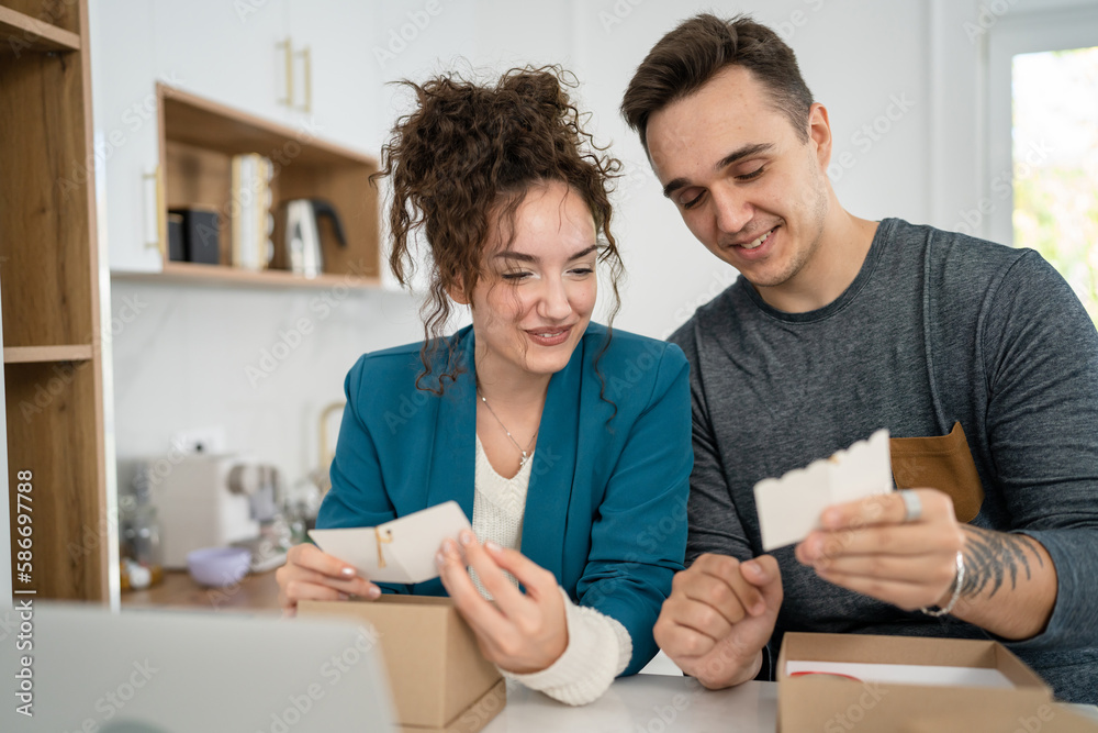 couple woman and man open presents and read card while on video call couple woman and man open presents and read card while on video call
