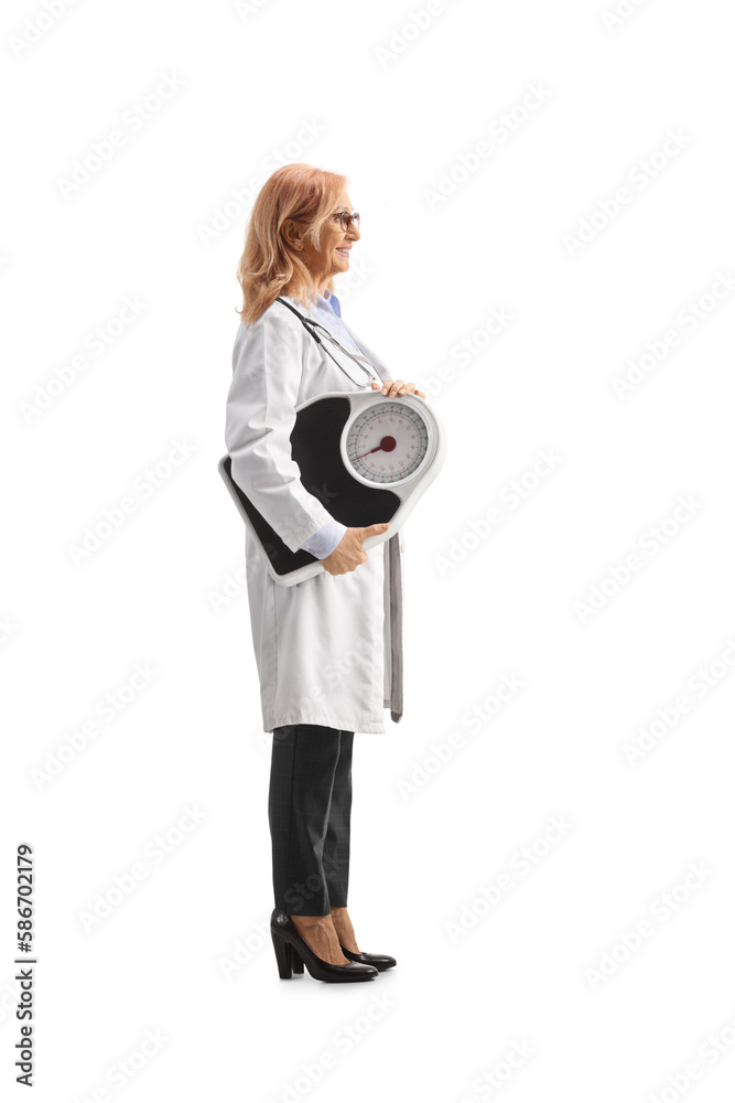 Full length profile shot of a female doctor holding a weight scale Full length profile shot of a female doctor holding a weight scale