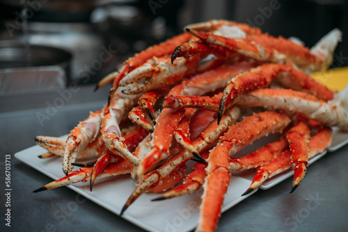 Legs of fresh red Kamchatka crab on the table in the restaurant kitchen. Freshly frozen crab meat for cooking