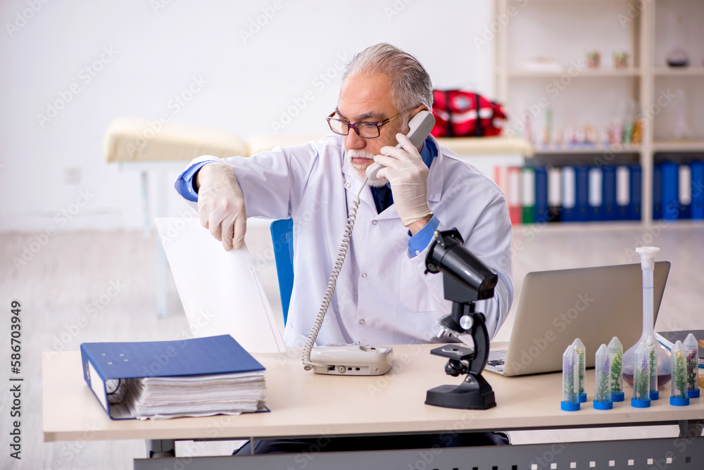 Old male chemist in drugs synthesis concept Old male chemist in drugs synthesis concept