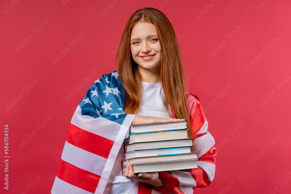 American woman student holds stack of university books from library on pink American woman student holds stack of university books from library on pink