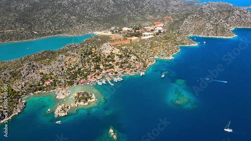 Aerial view of Simena Castle (Kaleköy), beach, and yachts, showcasing the captivating blend of history, nature, and Mediterranean culture in Antalya, Turkey. photo