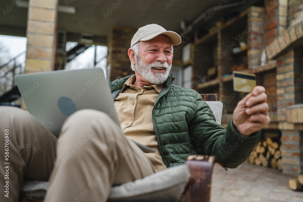 Man senior caucasian male shopping online sit with laptop computer Man senior caucasian male shopping online sit with laptop computer