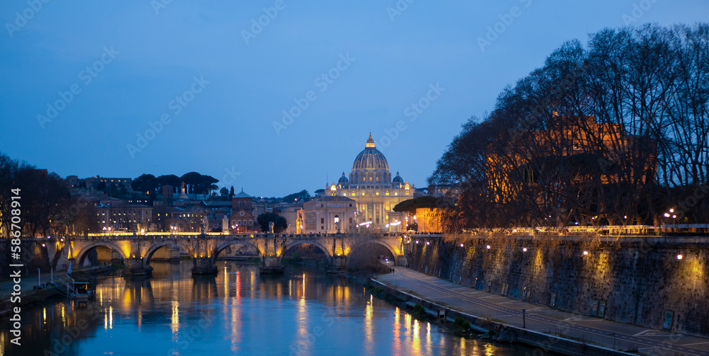 Castel Sant'Angelo bridge in Rome, Italy with statues of angels. In the background the basilica of San Pietro and the castle can be glimpsed. This place is famous landmark in Rome. Travel theme.