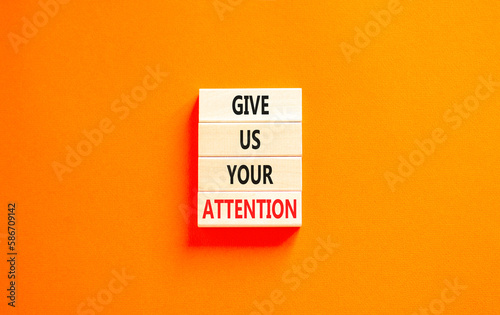 Give us your attention symbol. Concept words Give us your attention on wooden block. Beautiful orange table orange background. Motivational business give us your attention concept. Copy space.