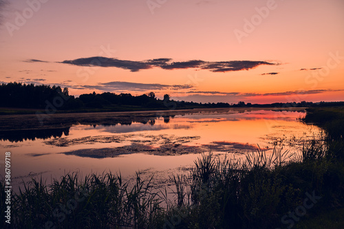 Fototapeta Naklejka Na Ścianę i Meble -  Red sunset over the pond in Czajki