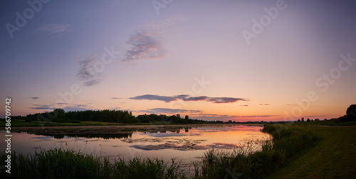 Colorful sunset over the lagoon near the fores