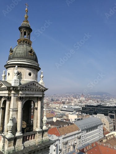 Budapest, Hungary: close up of a bell tower on St Stephen's Basilica (Szent István-bazilika) from the church's dome. Budapest cityscape in the background. 
