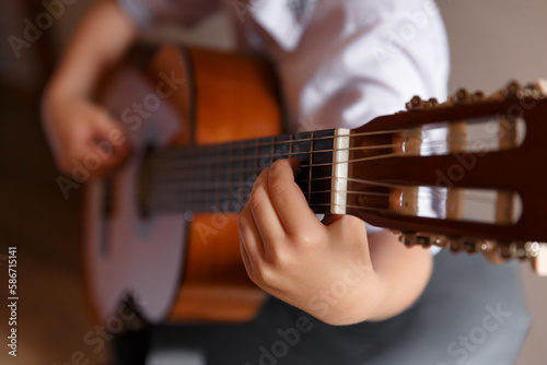 Young handsome guitar player, boy with guitar, children playing the guitar