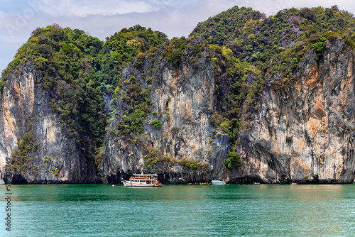 Ship with tourists near famous place in Phang Nga bay near James Bond island, Phuket. Travel to a fabulous warm country. Thailand.