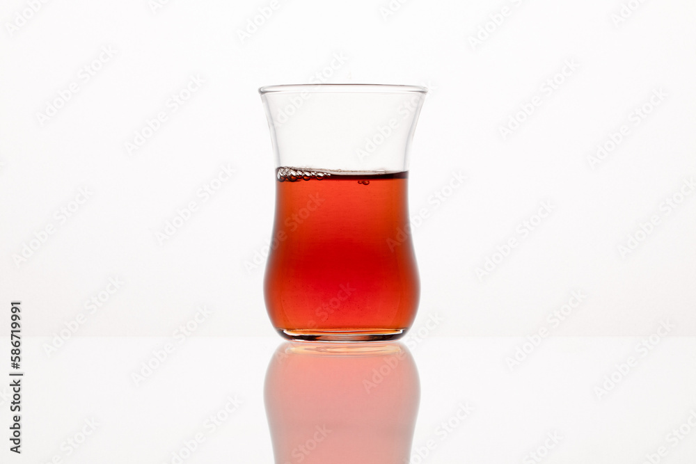 Traditional Turkish tea glass with tea. Traditional Turkish tea glass with tea.