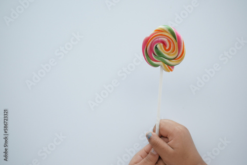  child holding a lollipop candy 
