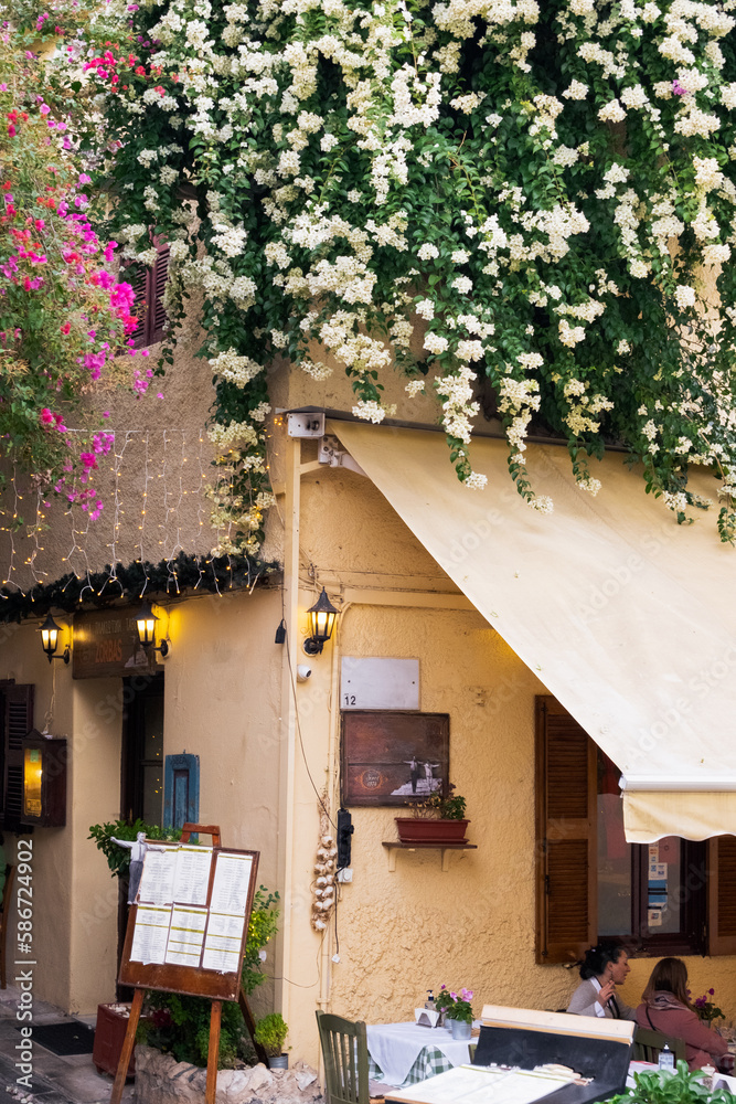 Obraz premium Traditional houses in famous Plaka, Athens,Greece. Old Town of Athens, Greece. Beautiful flowers near the house.