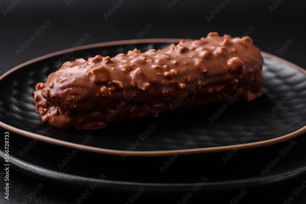 Delicious fresh eclair cake or profiterole with chocolate and nuts Delicious fresh eclair cake or profiterole with chocolate and nuts