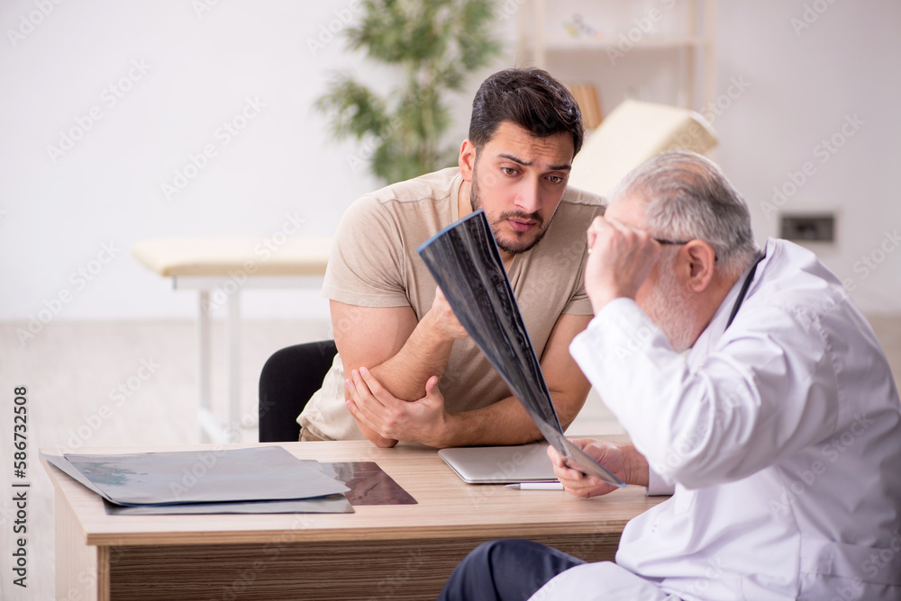 Young male patient visiting old male doctor radiologist