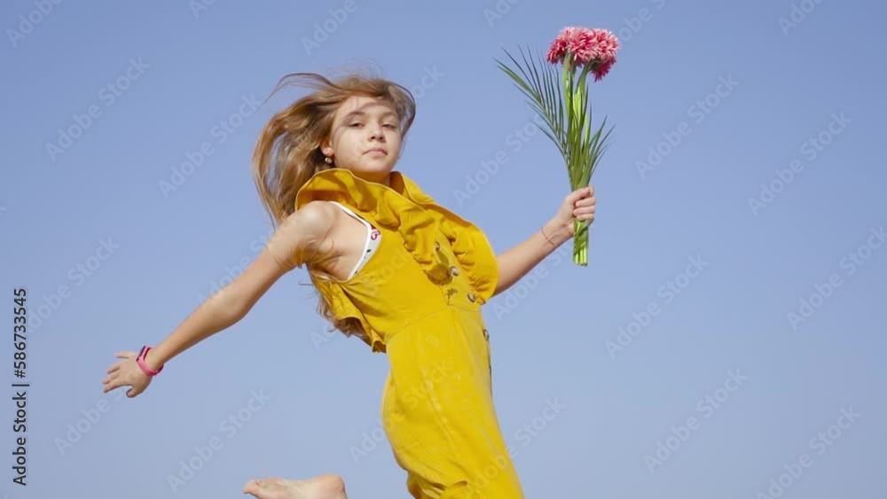 Girl in jump in slow motion with flowers in hand Girl in jump in slow motion with flowers in hand