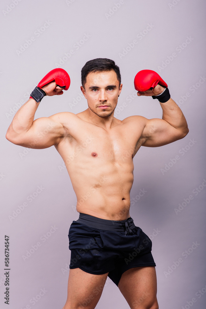 Professional athlete boxer in red gloves who isolated on studio. Sport, competition concept.