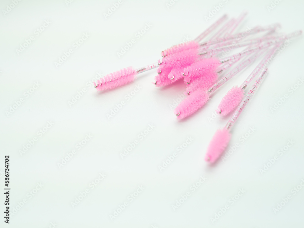 close up of pink brushes for combing eyelash extensions and brows close up of pink brushes for combing eyelash extensions and brows