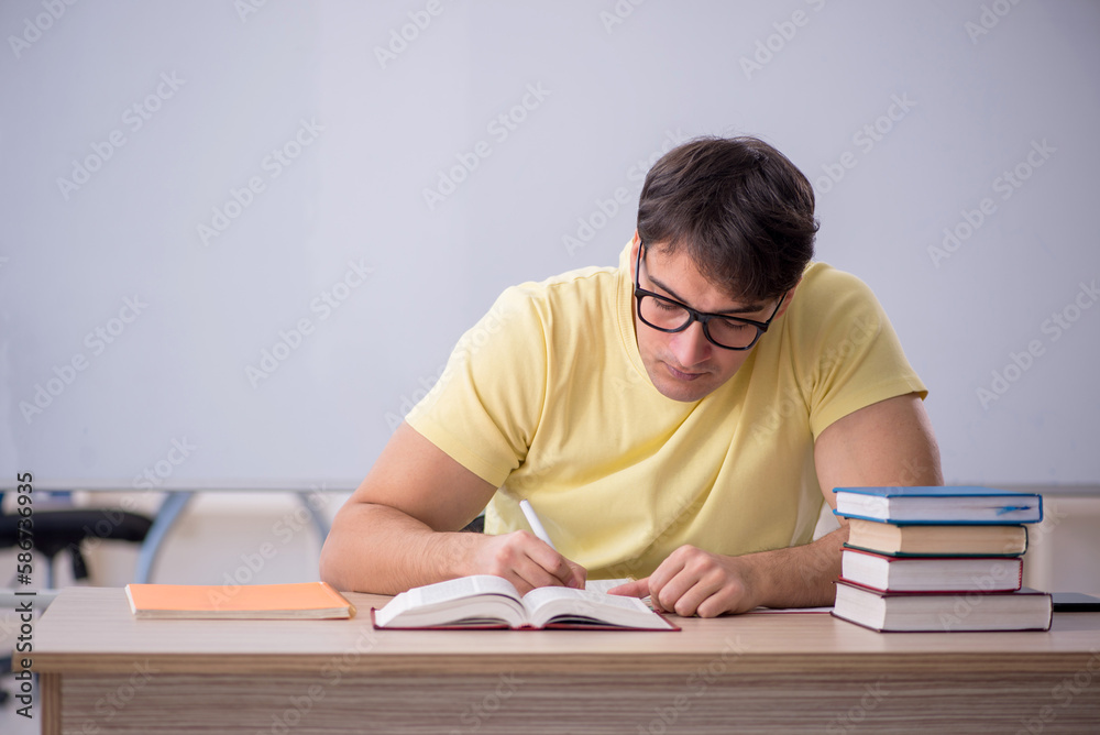 Young male student sitting in the classroom Young male student sitting in the classroom
