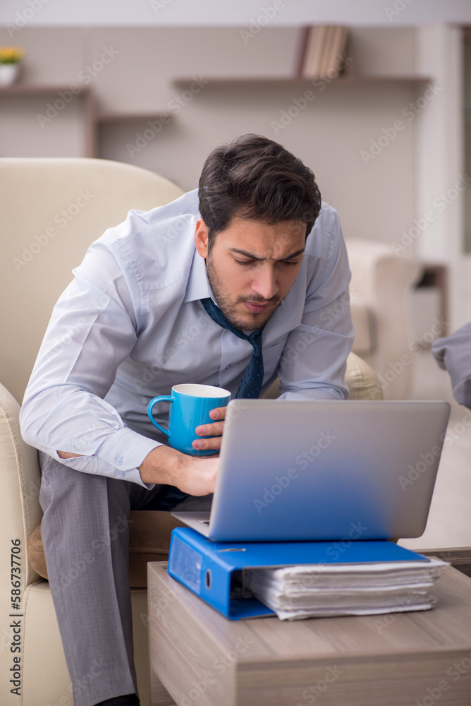 Young male employee working from home Young male employee working from home