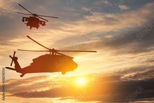 Silhouettes of helicopters on background of sunset. Greeting card for Veterans Day, Memorial Day, Air Force Day. USA celebration.