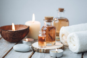 Foto auf Acrylglas Massagesalon Concept of spa treatment in salon with pure organic natural oil. Atmosphere of relax, detention. Aromatherapy, candles, towel, wooden background. Skin care, body gentle treatment  © ArtSys