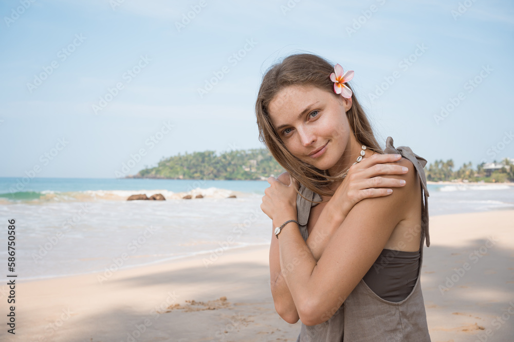 Beautiful blond suntanned young adult woman at sea coast background. Summer and vacation concept. Beautiful blond suntanned young adult woman at sea coast background. Summer and vacation concept.
