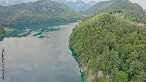 A stunning aerial view captures the picturesque Alpsee lake, located near the iconic Neuschwanstein castle.