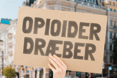 The phrase " Opioids kill " on a banner in men's hands is isolated on a white background. Medicine supply. Deadly drugs. Death. Treatment. Pharmacy. Dangerous. Drug addiction