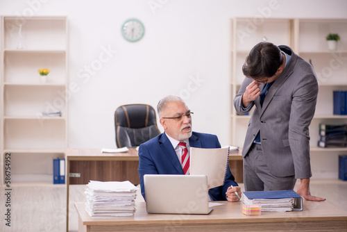 Two male colleagues sitting in the office