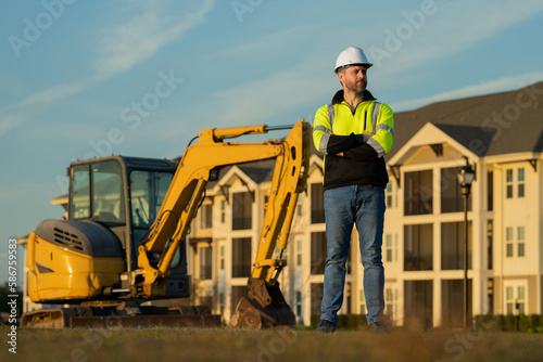 Worker at construction site. Builder constructor in hardhat. Construction man with helmet. Worker at construction with helmet. Industry worker at construction building. Builder at site building with
