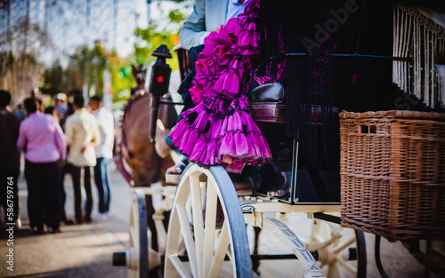 traditional fair in andalusia spain with woman on top of a car pushed by horses