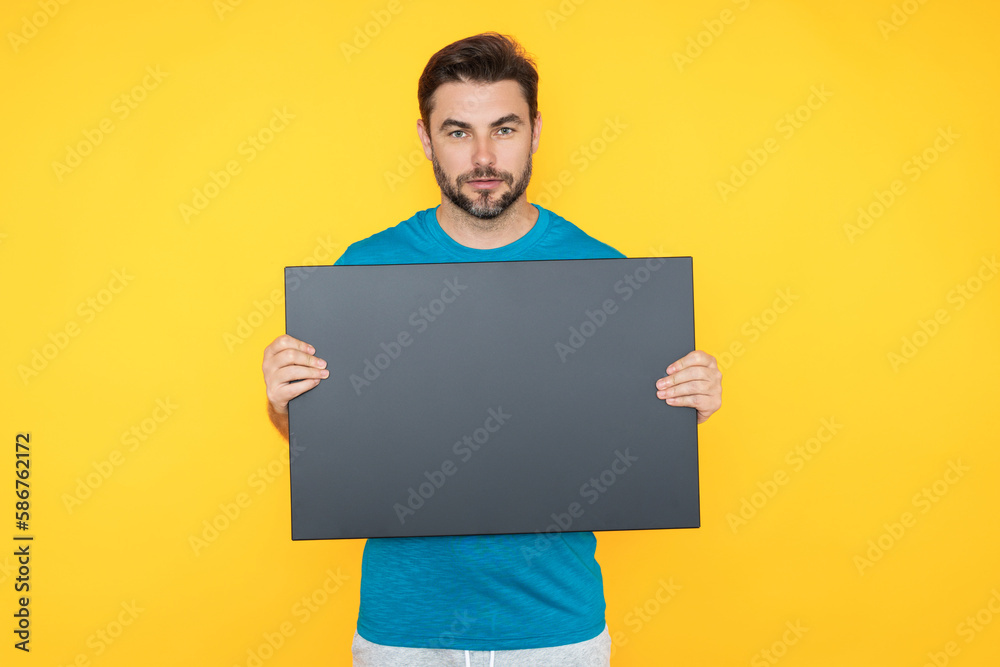 Information concept. Man with blank placard. Demonstrating copy space for your text or design. Man showing empty advertisement board on studio background. Blank placard with copy space, signboard. Information concept. Man with blank placard. Demonstrating copy space for your text or design. Man showing empty advertisement board on studio background. Blank placard with copy space, signboard.