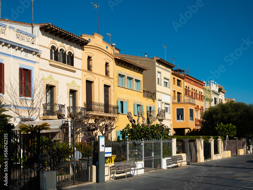 Scenic view of Spanish city of Vilassar de Mar overlooking typical buildings along street on sunny day, Catalonia photo