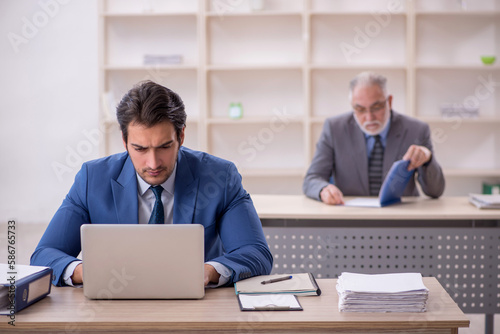 Two male colleagues working in the office