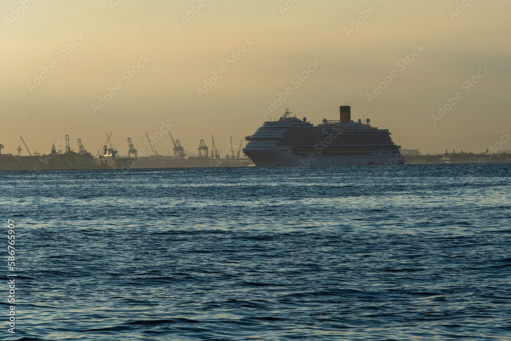 Transatlantic ship in Guanabara Bay in Rio de Janeiro, Brazil with a hill in the background. Beautiful landscape with the sea at sunset. Sailing boats and speedboats in the bay Transatlantic ship in Guanabara Bay in Rio de Janeiro, Brazil with a hill in the background. Beautiful landscape with the sea at sunset. Sailing boats and speedboats in the bay