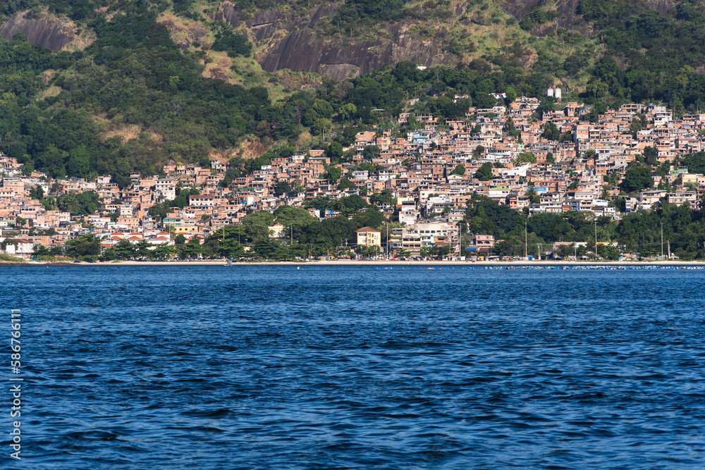 Jurujuba beach in Niterói, Rio de Janeiro, Brazil. Bathed by Guanabara Bay. Houses on the hill in the background. Beautiful landscape with the sea