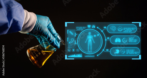 Horizontal shot of hand holding liquid in test tube close up on dark background. The concept of searching for an antiviral drug. photo