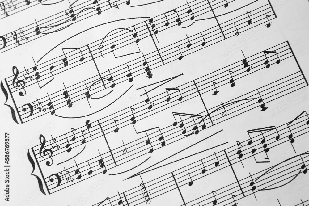 Sheet of paper with music notes as background, closeup view Sheet of paper with music notes as background, closeup view