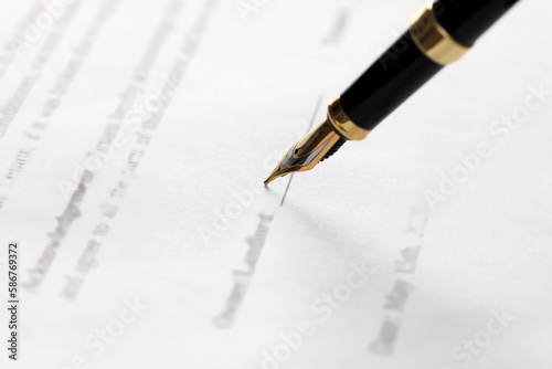 Writing on document with fountain pen, closeup. Notary contract